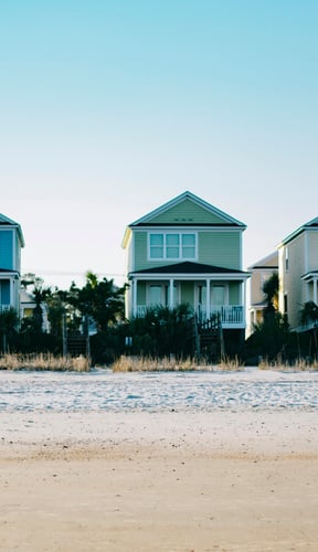 Row of colorful beach houses on white sand