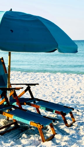 Beach chairs and teal umbrella on Destin Florida beach
