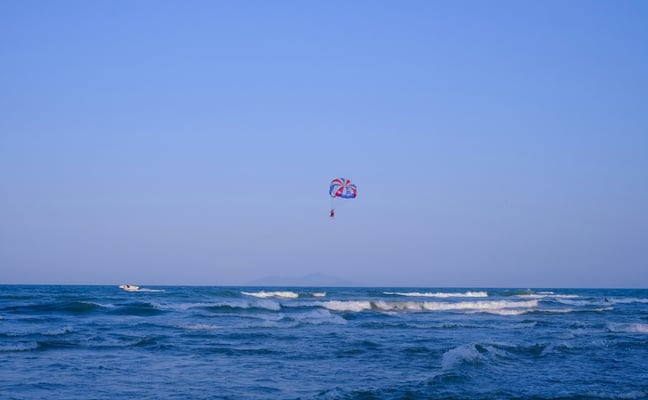 Parasail soaring over the blue ocean under a clear sky